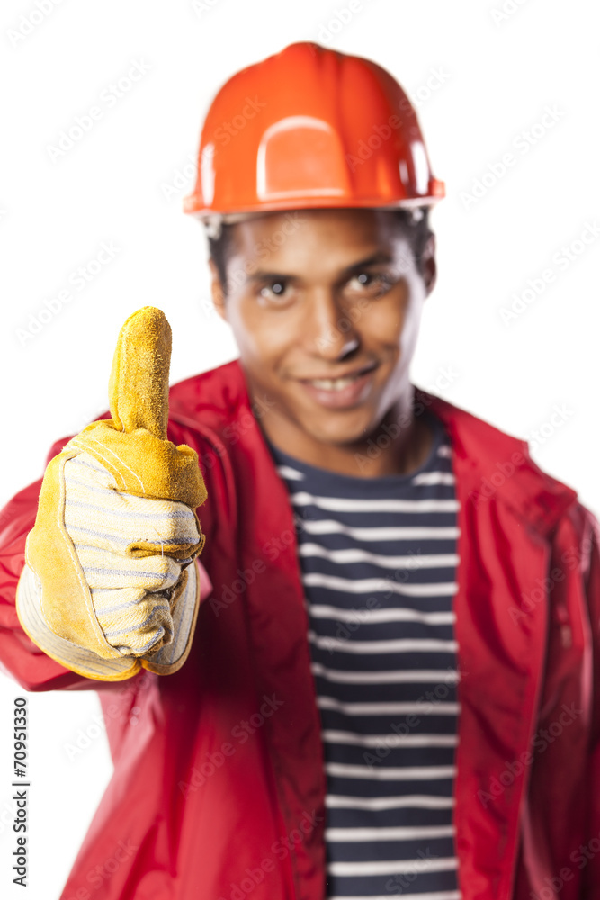 dark-skinned worker with helmet and gloves showing thumbs up dark-skinned worker with helmet and gloves showing thumbs up