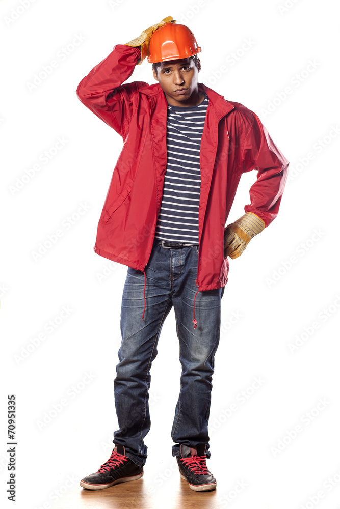 confused dark-skinned worker with helmet and gloves confused dark-skinned worker with helmet and gloves