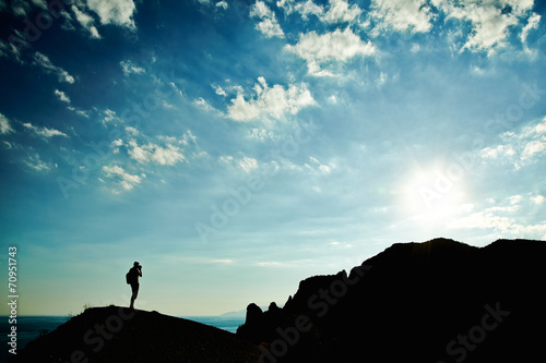Man silhouette at sunset in mountains