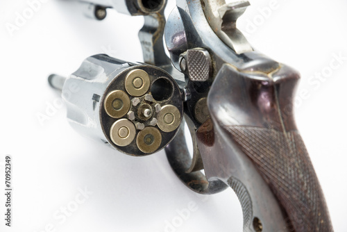A handgun revolver chamber is open showing ammunition gun ammo p