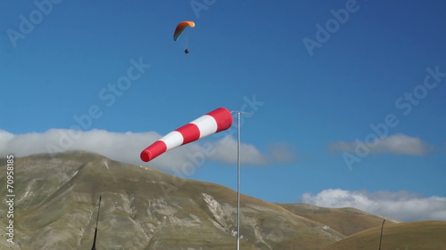 In mountains of Italy wind sleeve and paragliding