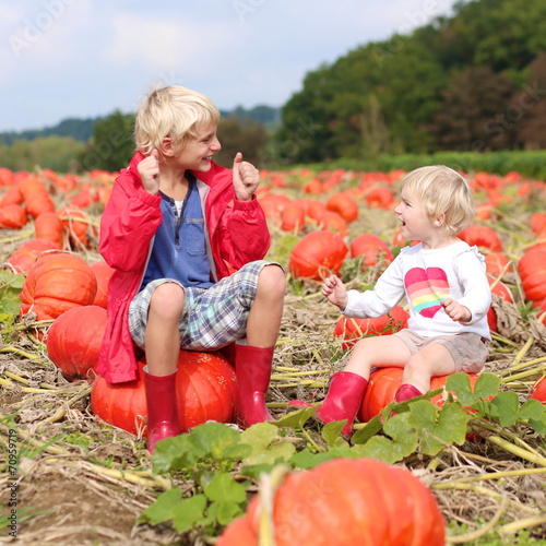 Kids having fun on pumpkin field