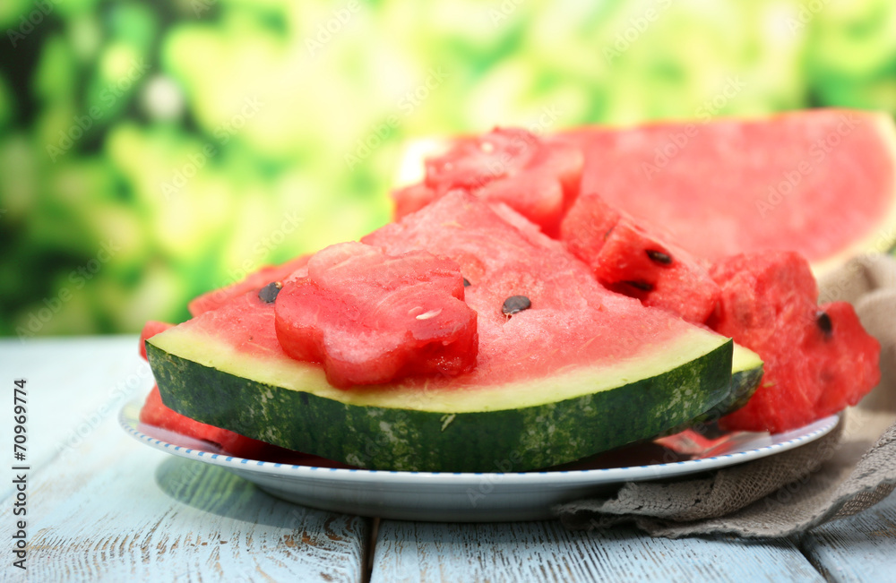 Fresh slices of watermelon on table, outdoors