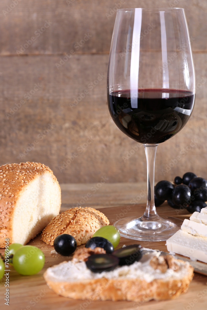 beautiful still life with wine, cheese and ripe grape