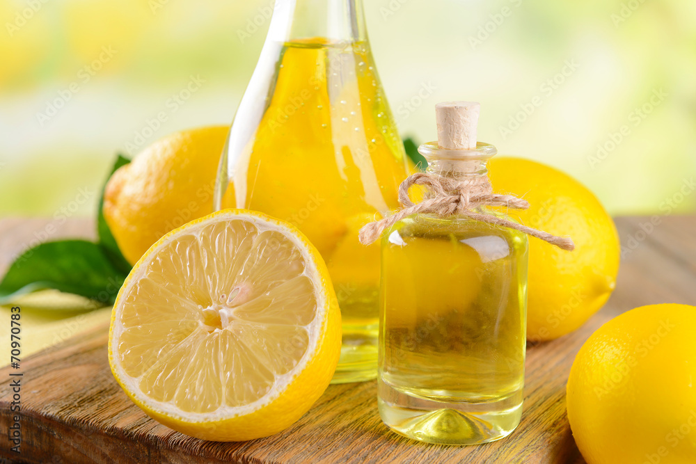 Lemon oil on table on light background Lemon oil on table on light background