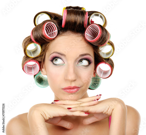 Beautiful girl in hair curlers isolated on white