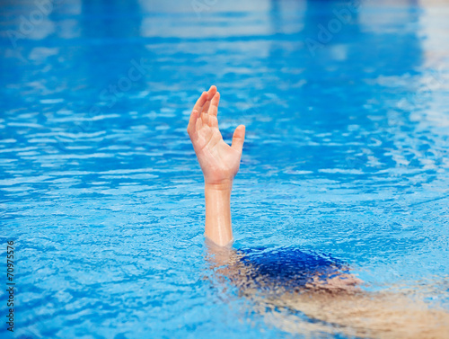 A hand of a drowning person stretching out of water.