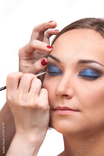 Hands closeup make-up artist applying makeup