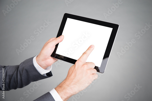 Hand pointing at tablet computer screen