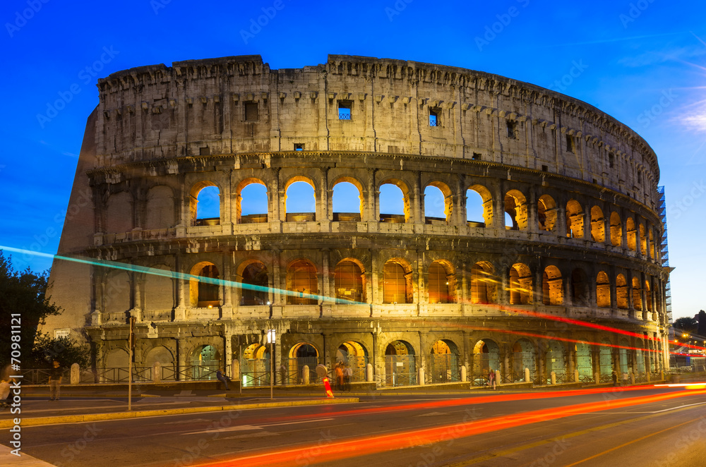 Night view of Colosseum with traffic lights in Rome, Italy