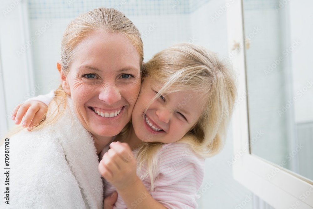 Happy mother and daughter smiling at camera Happy mother and daughter smiling at camera