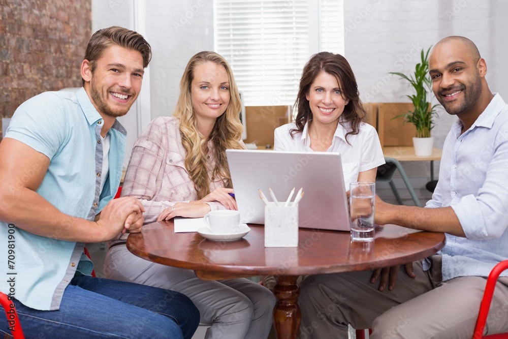 Smiling business team working together with laptop Smiling business team working together with laptop