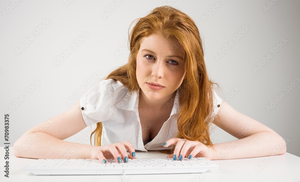 Pretty redhead typing on keyboard Pretty redhead typing on keyboard