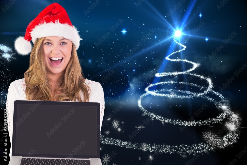 Composite image of festive blonde showing a laptop Composite image of festive blonde showing a laptop