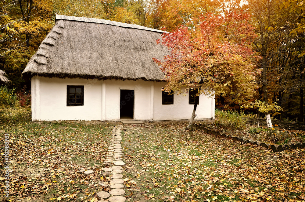 Old hut with a straw roof. Ukrainian Museum of Life and Architec Old hut with a straw roof. Ukrainian Museum of Life and Architec