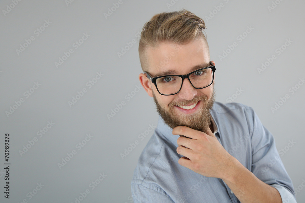 Trendy guy with hand on chin, isolated Trendy guy with hand on chin, isolated