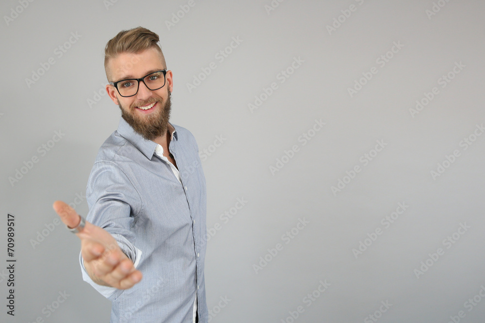 Smiling trendy guy giving hand for handshake Smiling trendy guy giving hand for handshake