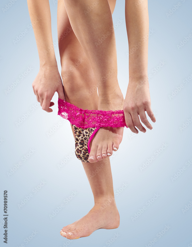 Sexy legs pulling panties down. Stock Photo