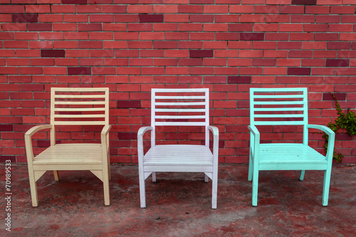 color wooden chair with brick wall background