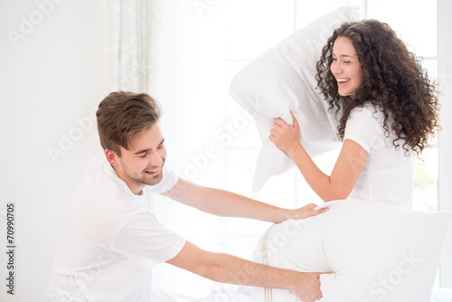 Couple pillow fighting