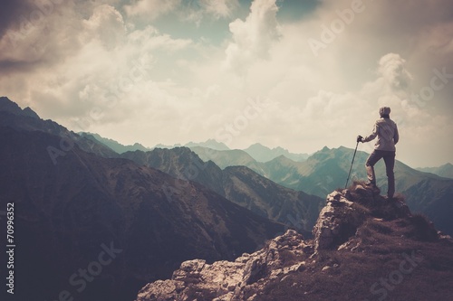 Woman hiker on a top of a mountain photo