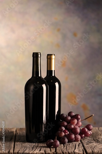 Wine bottles on wood floor and grunge background