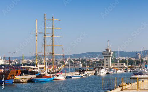 Big sailing ship and pleasure boats stand moored in Varna Port