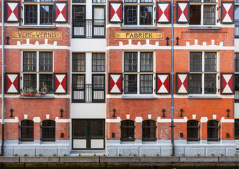 Exterior of quaint houses along a canal in Amsterdam, Netherland