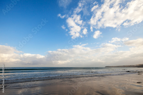 Atlantic ocean coast with bright blue cloudy sky