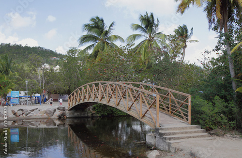 Foot bridge through channel. Les Trois-Îlets, Martinique photo