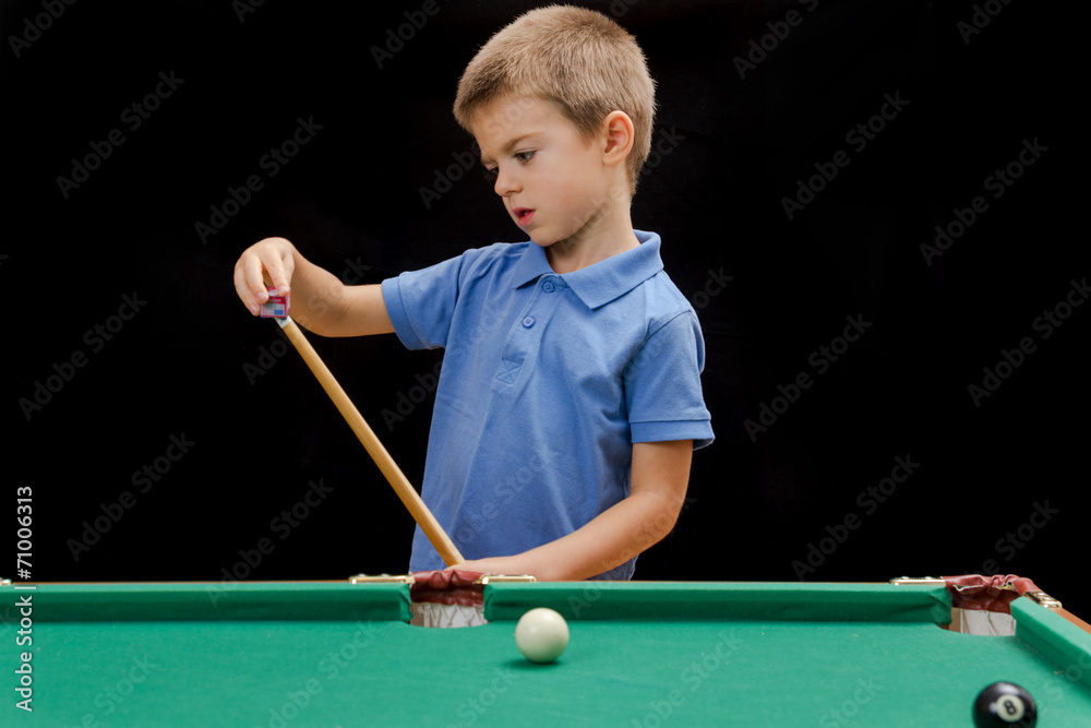 Fototapeta premium Beautiful boy playing billiard (pool)