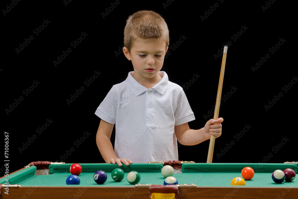 Fototapeta premium Beautiful boy playing billiard (pool)