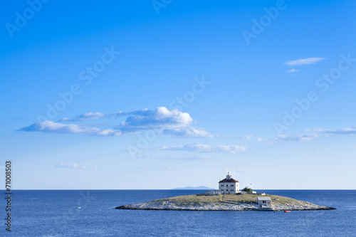 A lone island in the sea. Locaten in Croatia near island of Hvar photo