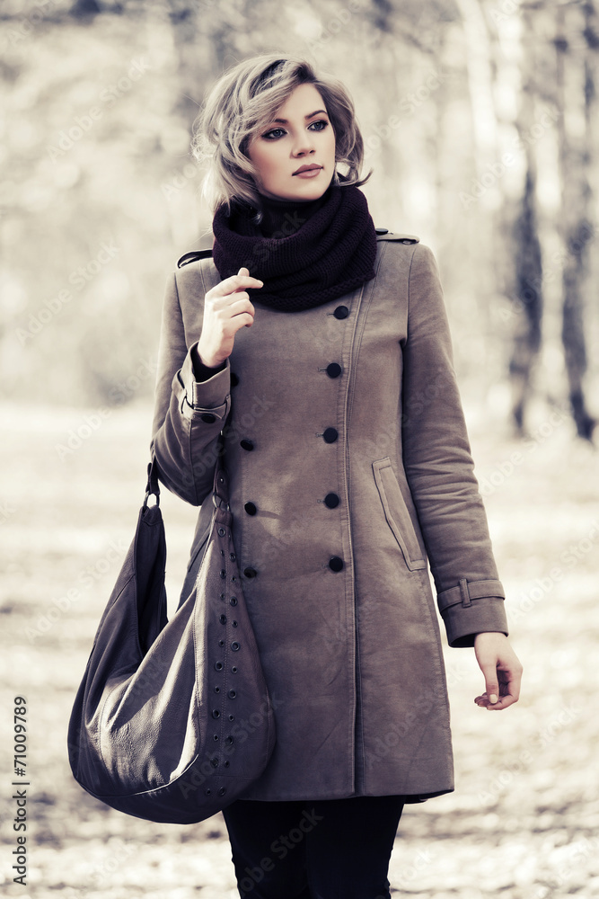 Young blond fashion woman walking in autumn forest Young blond fashion woman walking in autumn forest