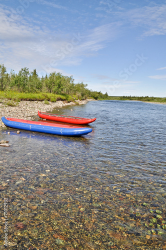 Two inflatable canoes on the shore of North river.