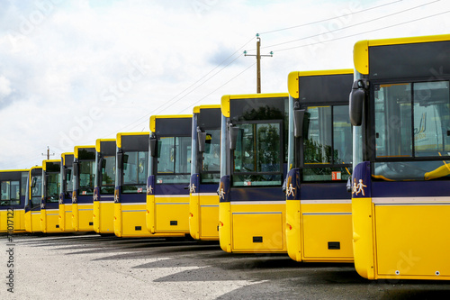 Big yellow buses parked in a line