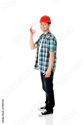 Portrait of a builder in a white helmet