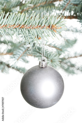 One separated christmas ball handing on a twig.