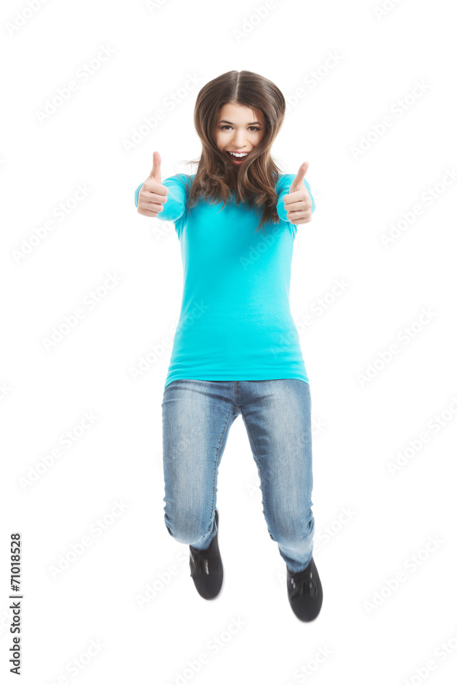 Casual woman jumping showing OK. Casual woman jumping showing OK.