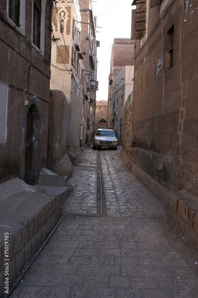 Narrow alley with car in Sanaa, Yemen