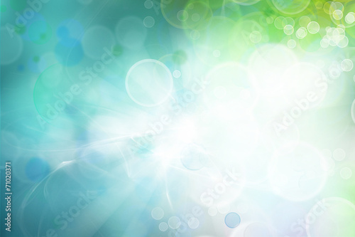 Abstract blue and green bokeh light blurs background. White copy space