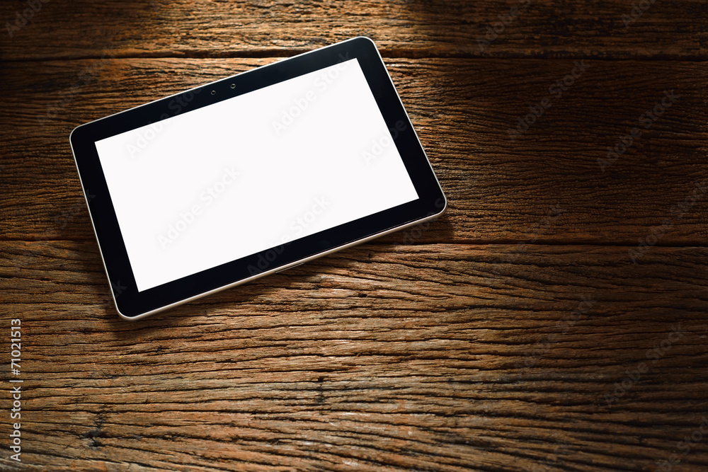 Tablet computer on old wooden background Tablet computer on old wooden background