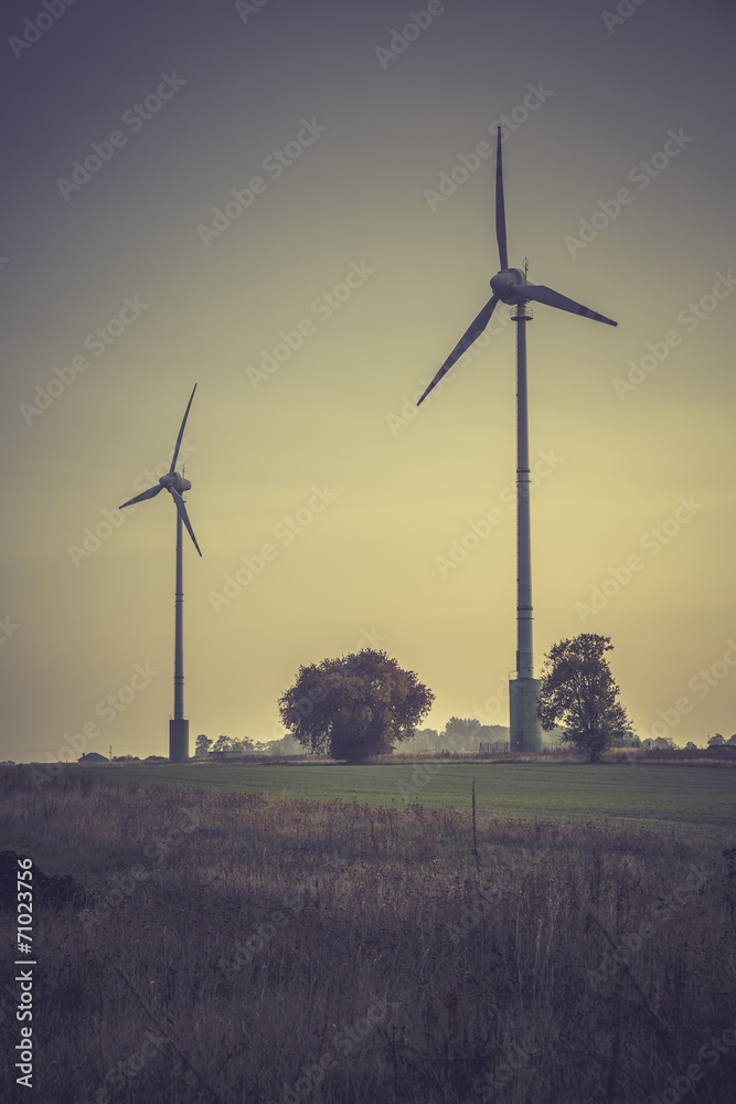 Wind turbines silhouette in the sunset sky Wind turbines silhouette in the sunset sky