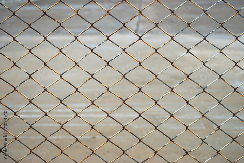 old rusty steel wire fence against blur background