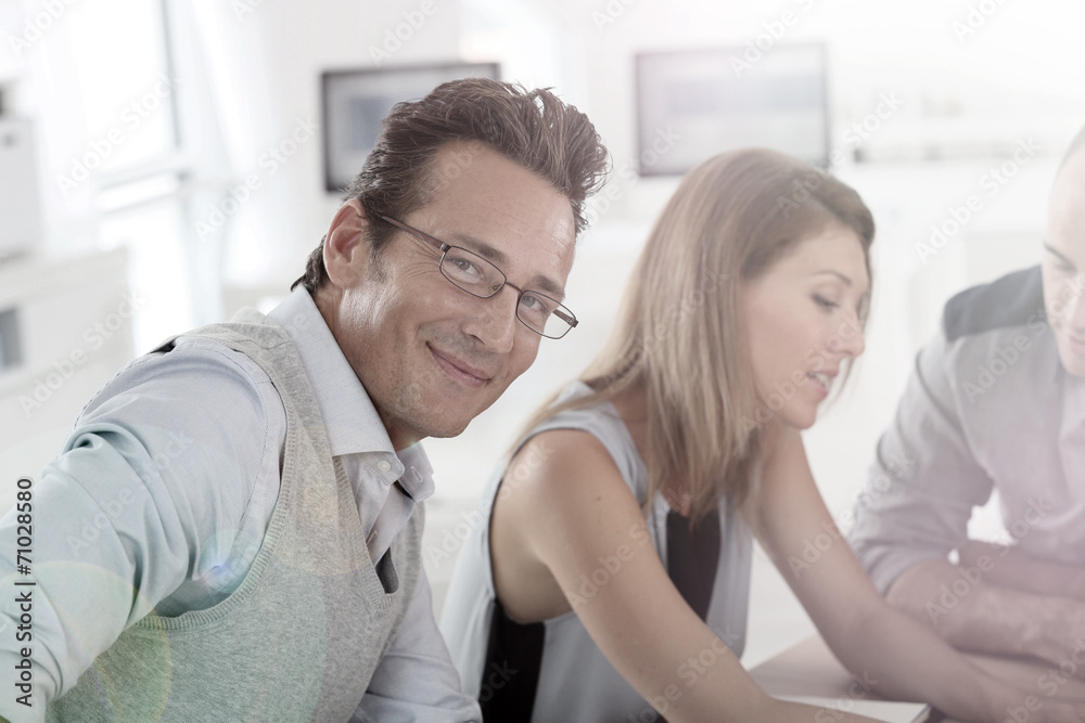 Mature businessman attending work meeting Mature businessman attending work meeting