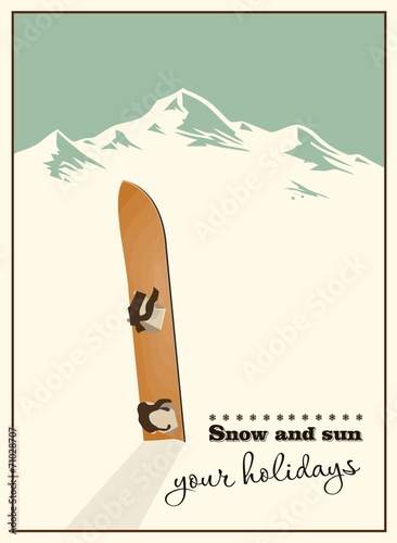 Winter  background. Mountains and old snowboard in the snow