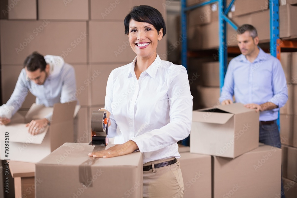 Warehouse workers packing up boxes Warehouse workers packing up boxes