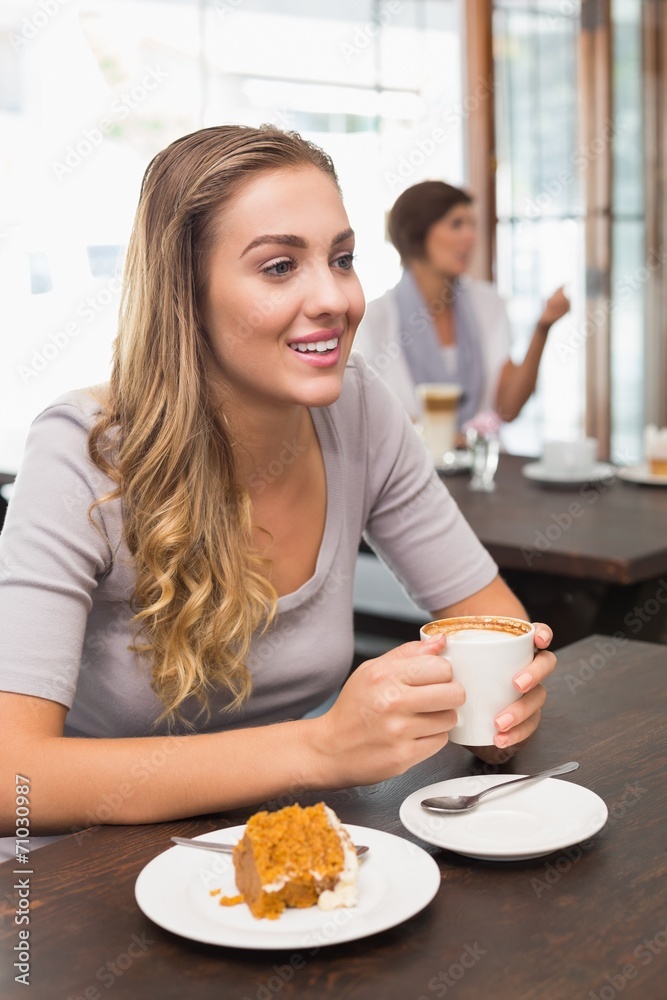 Pretty blonde enjoying cake and coffee Pretty blonde enjoying cake and coffee