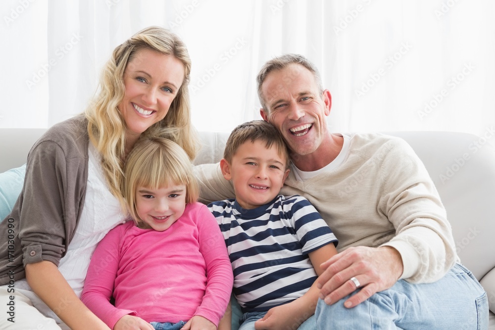 Portrait of a cheerful family on the couche Portrait of a cheerful family on the couche