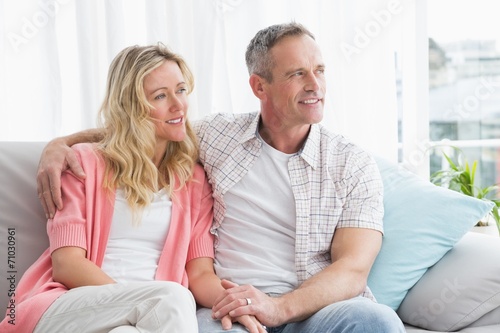 Smiling couple relaxing on the couch